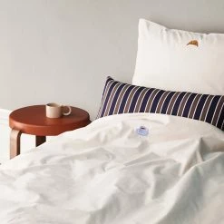 Normann Copenhagen Snooze -Louise Smærup shop normann copenhagen sengesaet normann copenhagen snooze happy hangover coral 1394094 scaled